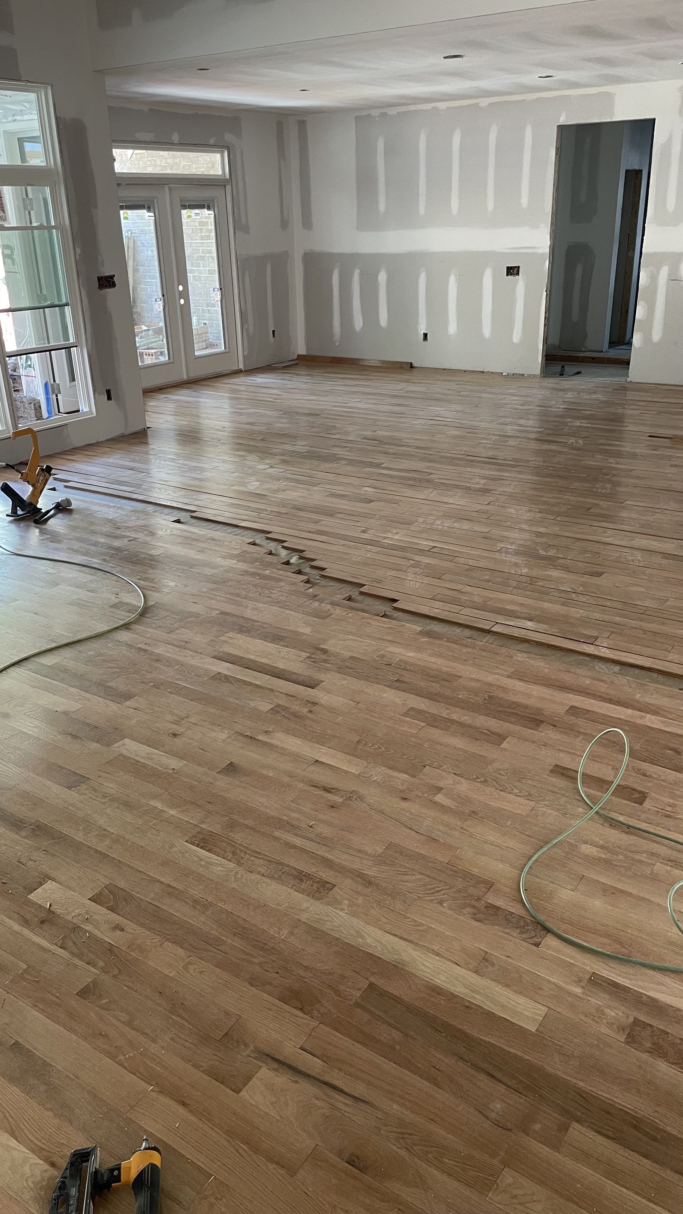 Presealed white oak hardwood being installed in a new home
