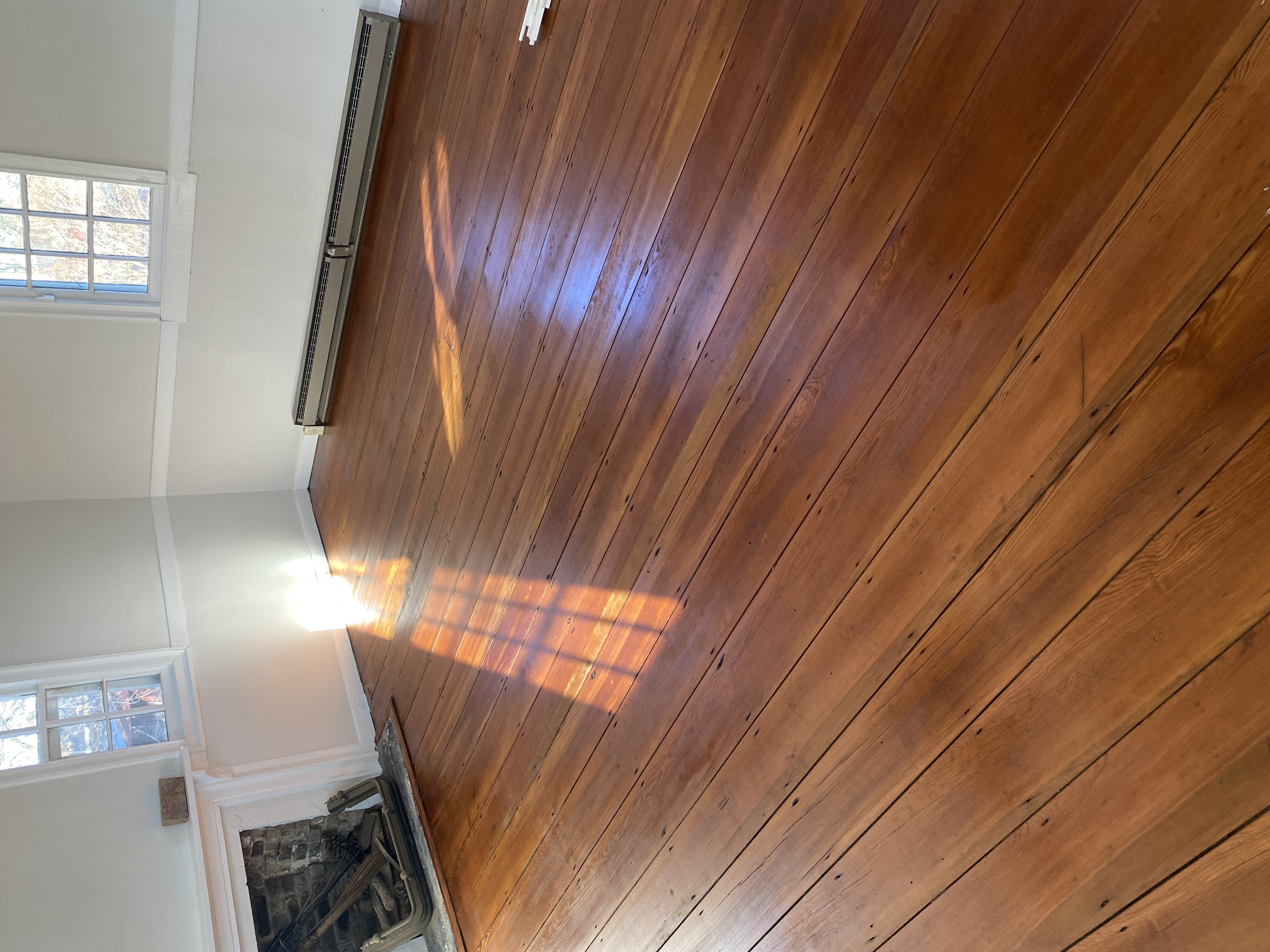 Restored antique hardwood flooring after sanding and refinishing