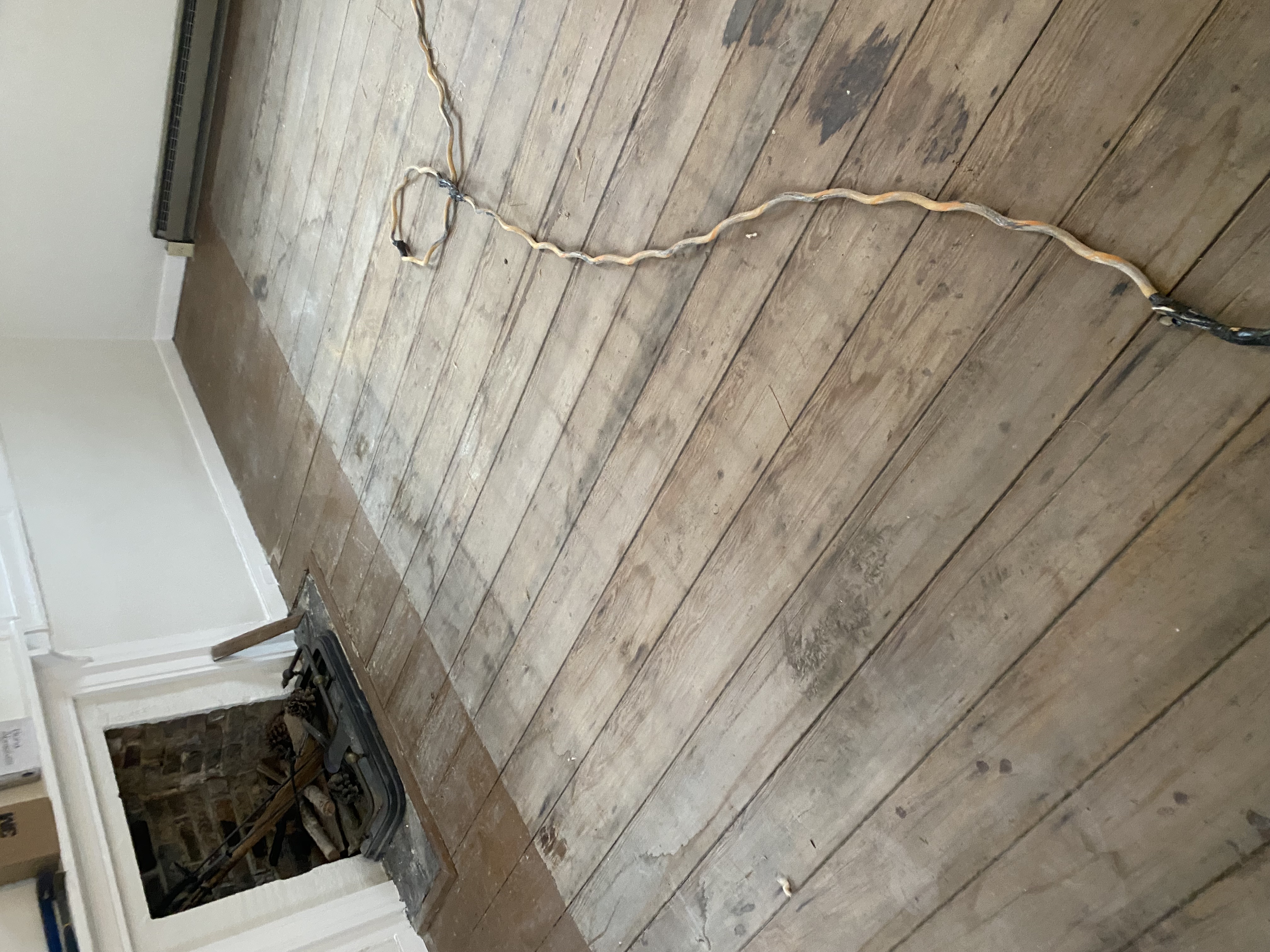 Worn antique hardwood flooring before restoration