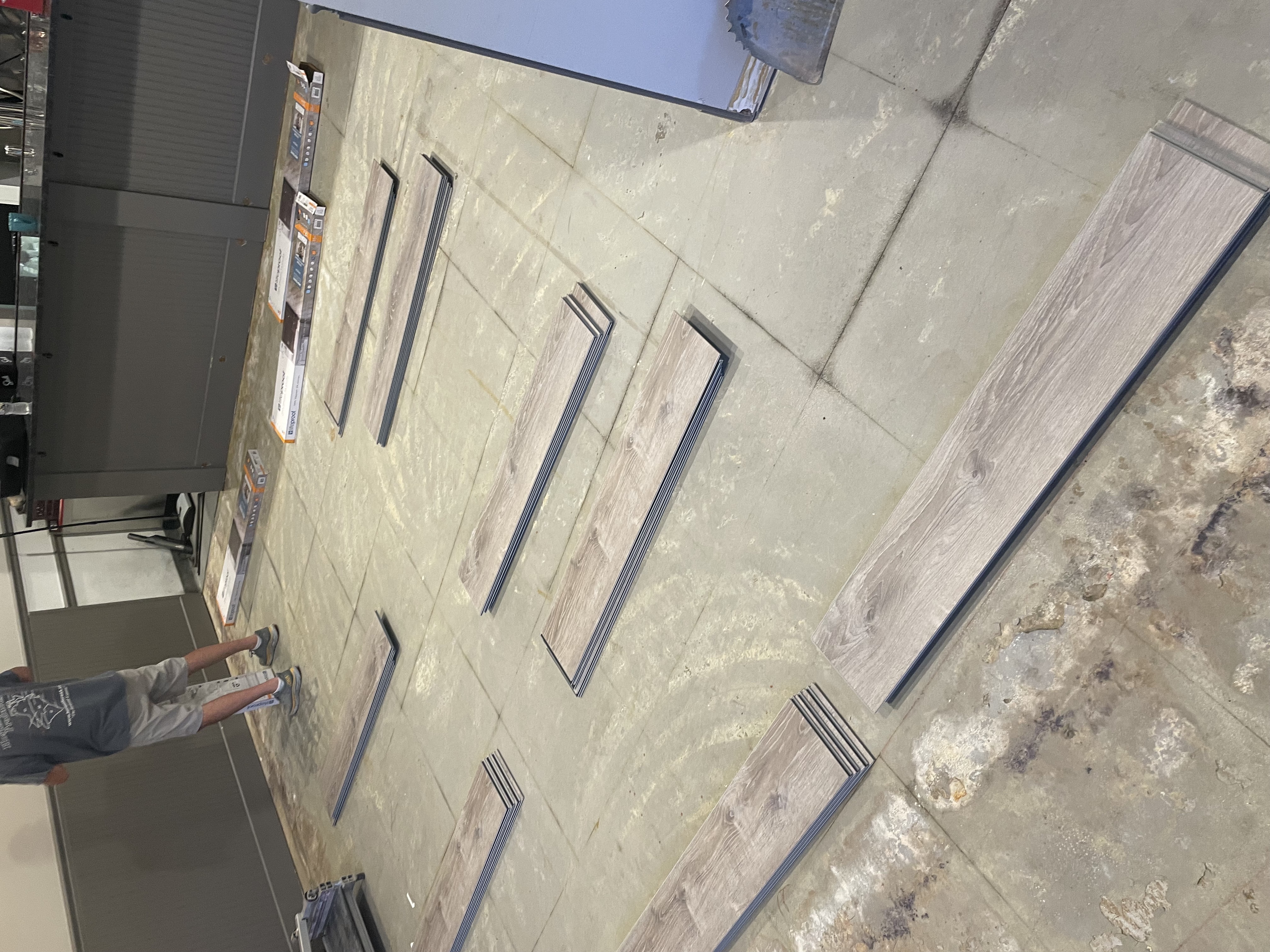 Luxury vinyl plank flooring laid out before installation in a commercial space