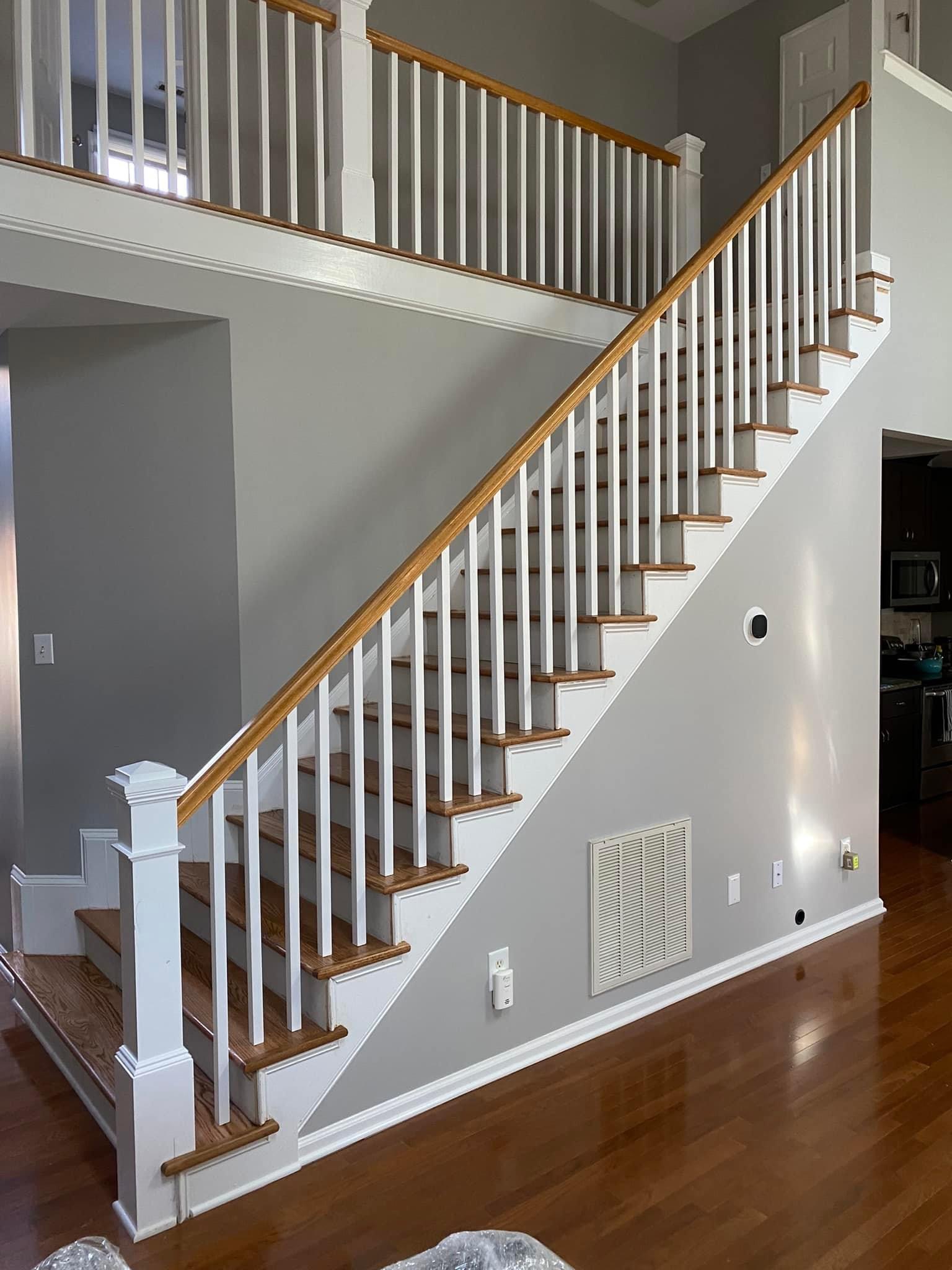 Finished hardwood stair treads and renovated banister in a home