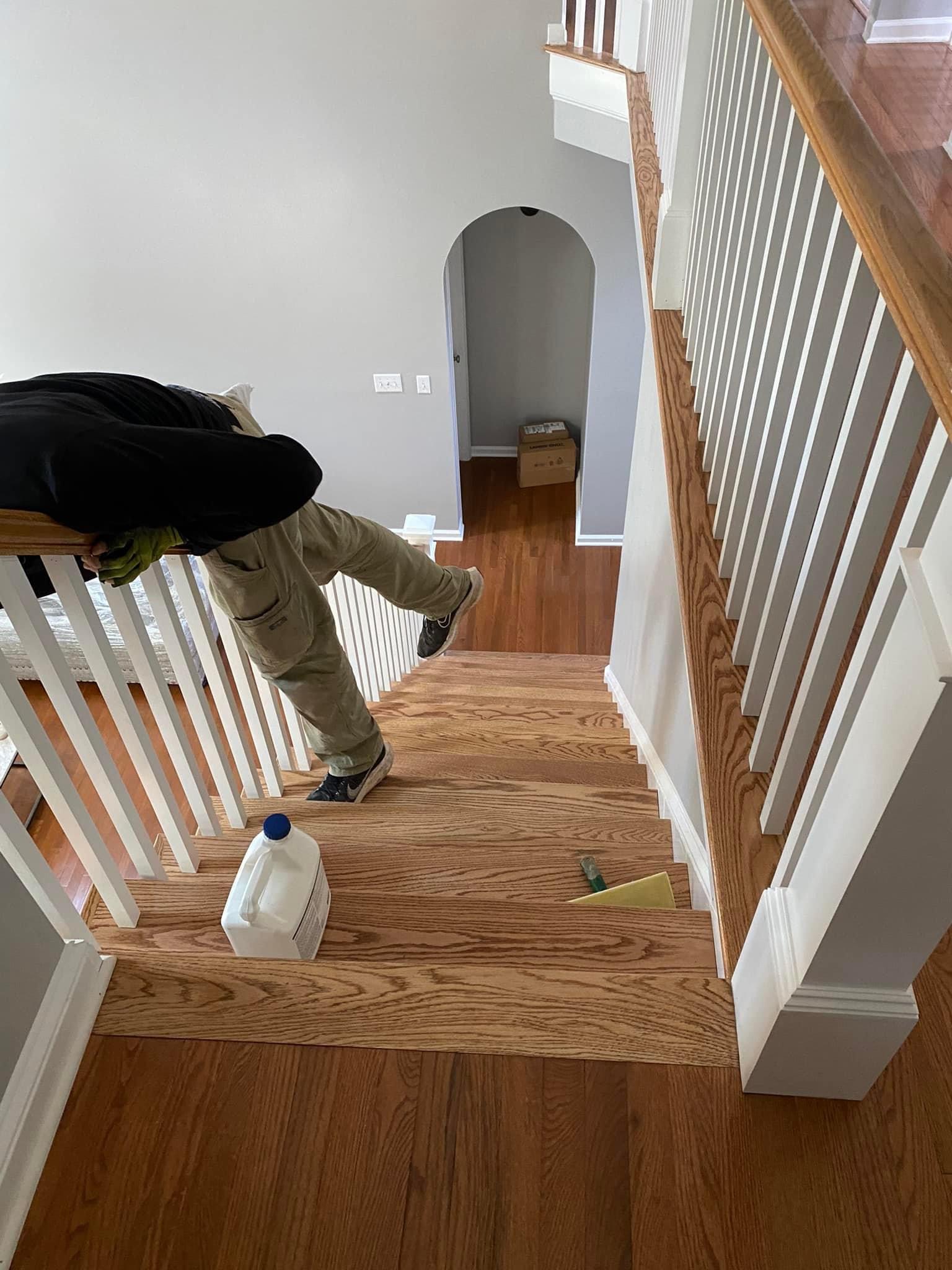 First coat of water-based finish being applied to the hardwood staircase